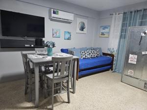 a living room with a table and a couch at KVC Apartamento Privado Aguadilla in Aguadilla