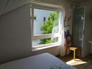 a bedroom with a bed and a window at Holiday apartment Wiedmann in Tübingen