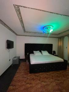 a bedroom with a bed with a green ceiling at Ikorodu Guest House in Lagos