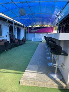 a row of bar stools under a blue ceiling at Ikorodu Guest House in Lagos