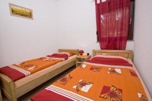two beds sitting next to each other in a room at Holiday Home Lana in Korenica +46 photos