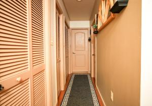 a hallway with a white door and a tile floor at Urban Elegance in Philadelphia