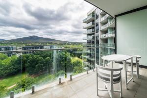 a balcony with a table and chairs on a building at Executive Balcony Apartment in Central Canberra in Canberra