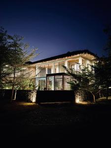 爱妮岛El Nido Lio Inland Villa的一座大房子晚上灯火通明