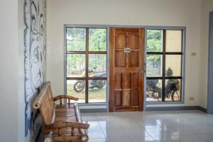 een kamer met een houten deur en een houten bank bij Fardesam - Budget Friendly Guest House in Siquijor