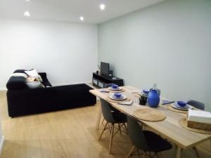 sala de estar con mesa y sofá en Ground Floor Terrace Flat by Porto en São Mamede de Infesta