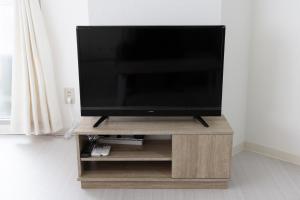 a flat screen tv sitting on a wooden stand at Oriental Sendagaya 401 #MOS in Tokyo