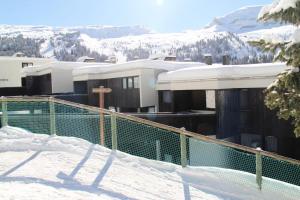 a building on top of a snow covered mountain at Résidence Belier - 2 Pièces pour 6 Personnes 84 in Flaine