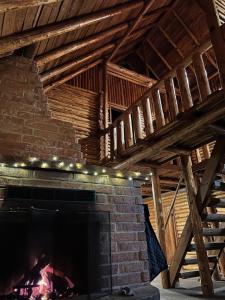 a brick fireplace in a room with wooden ceilings at Log Cabin at Rainier Lodge (0.4 miles from entrance) in Ashford