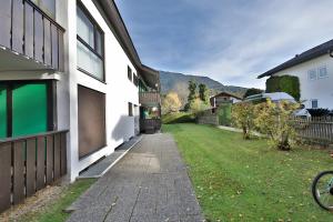 a house with a grass yard next to a building at Alpenhimmel in Garmisch-Partenkirchen