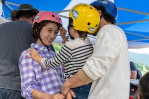 a group of children wearing helmets standing in front of a helicopter at Phoenix Resort Pyeongchang in Pyeongchang