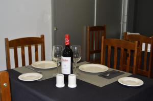 a bottle of wine sitting on a table with glasses at Hotel La Colombina in San Sebastián de la Gomera