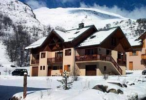 a large building with snow on top of a mountain at Chalet Les Lupins - 4 Pièces pour 8 Personnes 14 in Valloire