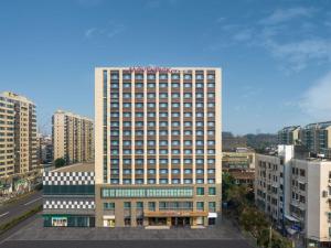 a tall building in the middle of a city at Mövenpick by Accor Binjiang Nanjing in Nanjing