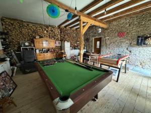 a living room with a pool table in a room at Escapade campagnarde dans ancien corps de ferme in Molsheim