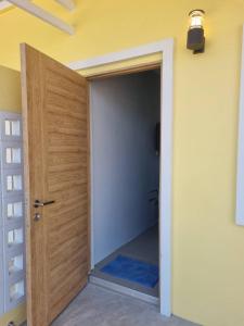 a door leading into a hallway with a blue rug at Rest at Thachang Hotel in Ban Hua Han