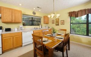 a kitchen with a wooden table and wooden cabinets at Among The Clouds 2240 in Gatlinburg