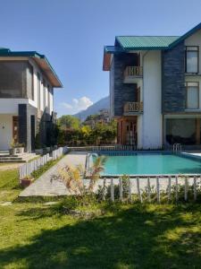 a house with a swimming pool in a yard at Smile Resort , Himachal Pradesh in Shamshi