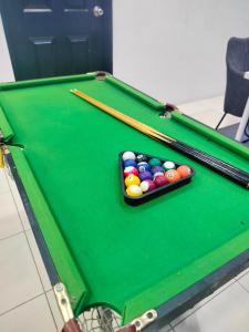 a green pool table with billiard balls on it at Doleena's Homestay in Sitiawan