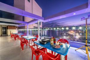 un restaurante con mesas azules y sillas rojas en Yeosu My Stay Pension, en Yeosu