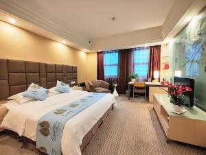 a hotel room with a large bed and a desk at Chongqing Milky Way Hotel in Chongqing