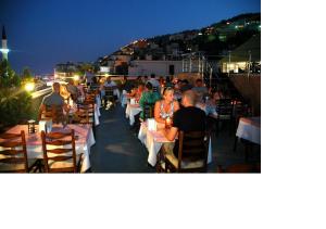 a group of people sitting at tables on a roof at ERGÜN OTEL in Alanya