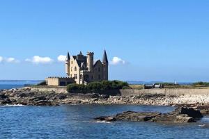a castle on an island in the water at Appartement Ty Cosy in Quiberon
