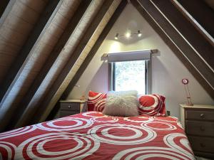 a bedroom with a large bed in a attic at Brindabella Chalet alpine-getaways in Dinner Plain