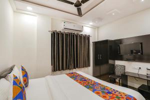 a hotel room with a bed and a kitchen at FabHotel Royal Stay in Nagpur