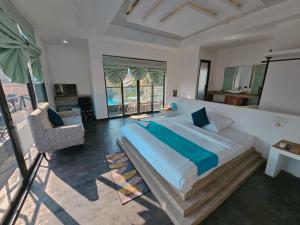 a bedroom with a large bed and a balcony at Angkor Sand Hotel in Siem Reap