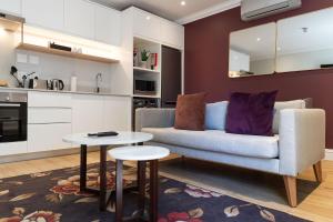 a living room with a couch and a table at Protea Hotel by Marriott Franschhoek in Franschhoek