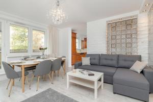 a living room with a couch and a table at Spacious Family Apartment with 3 Bedrooms in Gdansk by Renters in Gdańsk