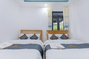 Postel nebo postele na pokoji v ubytování Palm 14 DaLat - In Nam Ho Resort