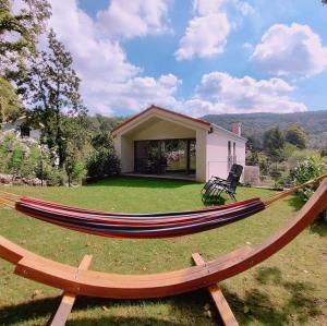 a large hammock in the yard of a house at Holiday house Sara in Kozina