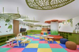 a classroom with tables and chairs and a colorful floor at Renaissance Danang Hoi An Resort & Spa in Hoi An +76 photos