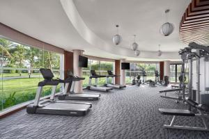 a fitness room with treadmills and elliptical machines at Renaissance Danang Hoi An Resort & Spa in Hoi An