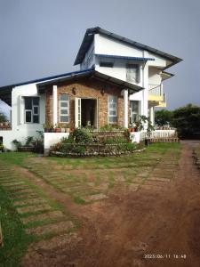 ein Haus mit einem unbefestigten Hof davor in der Unterkunft LaMansion Inn in Cherrapunji