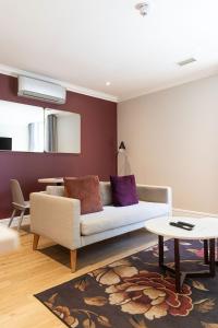 a living room with a couch and a table at Protea Hotel by Marriott Franschhoek in Franschhoek