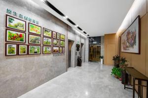 a hallway of a building with paintings on the walls at Huaian Reykana Hotel in Huai'an