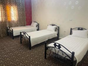 two beds sitting in a room with at Nabatean NIghts Home Stay in Wadi Musa