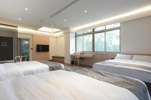 Voodi või voodid majutusasutuse Hoya Hot Springs Resort, Guanziling toas