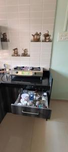 a kitchen with a stove and some food on a counter at Siddhi Sea View Bungalow Ganpatipule in Ratnagiri