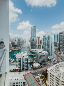 a view of a city with a river and buildings at Cozy 1 BR in Dubai Marina in Dubai