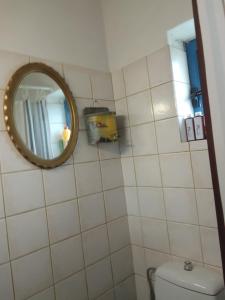 a bathroom with a mirror and a toilet at Spitiko Marias in Tséria