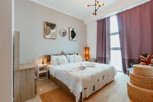 a bedroom with a large bed and a large window at Cozy 1 BR in Dubai Marina in Dubai