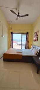 a large bed in a room with a window at Riddhi Sea View Bungalow in Ratnagiri