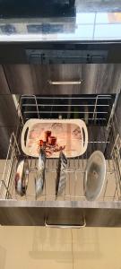 a rack in an oven with a bottle and utensils at Riddhi Sea View Bungalow Ganpatipule for Family in Ratnagiri