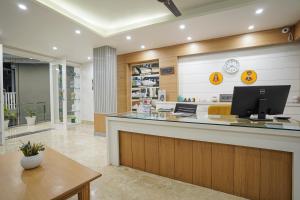 a lobby with a counter with a computer on it at Tripli Hotels Ayushman Retreat in Rishīkesh
