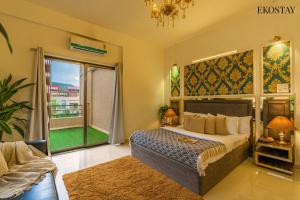 a bedroom with a bed and a large window at Ekostay Gold - Olive Crest Villa - Spacious Lawn in Lonavala