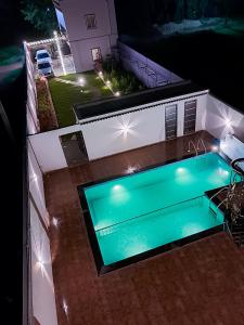an overhead view of a swimming pool at night at P Villa in Devanhalli